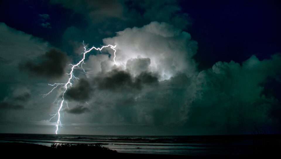 Lightning bolt over ocean during thunderstorm in Dedham, MA