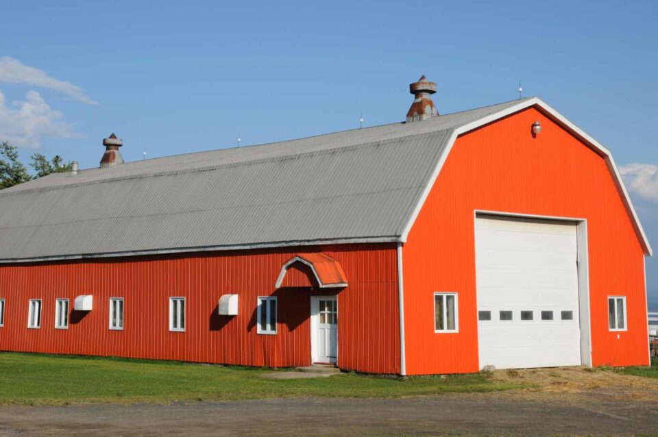 Red barn with lightning protection system by Boston Lightning Rod Co. Inc.
